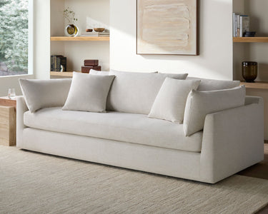 Beige sofa in a living room with neutral decor